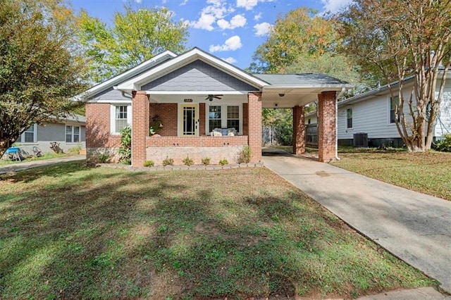 view of front of property featuring a front lawn, central AC unit, a porch, and a carport