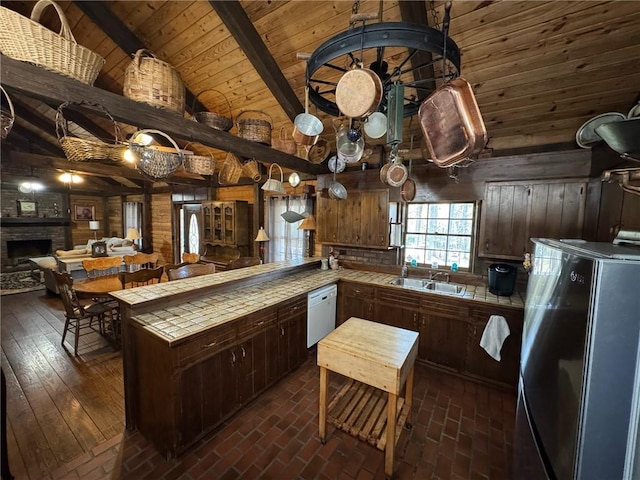 5834 Heardsville Rd, Cumming, GA 30028 - kitchen with refrigerator, tile counters, a sink, and a peninsula