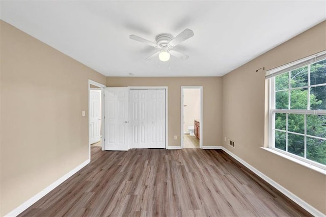 4701 Flat Shoals Rd Unit 37H, Union City, GA 30291 - unfurnished bedroom with wood finished floors, baseboards, a closet, and ensuite bath