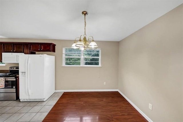 4701 Flat Shoals Rd Unit 37H, Union City, GA 30291 - kitchen featuring white appliances, a chandelier, baseboards, pendant lighting, and light wood finished floors