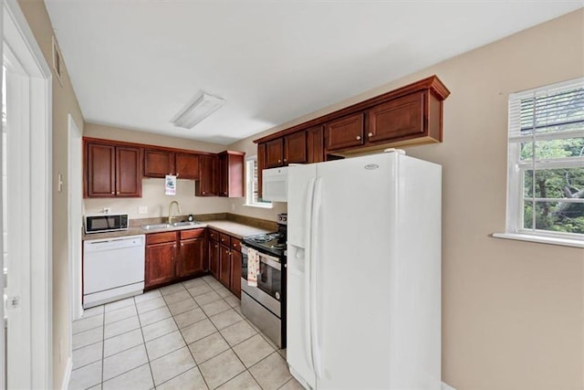 4701 Flat Shoals Rd Unit 37H, Union City, GA 30291 - kitchen featuring white appliances, a sink, light tile patterned floors, and light countertops