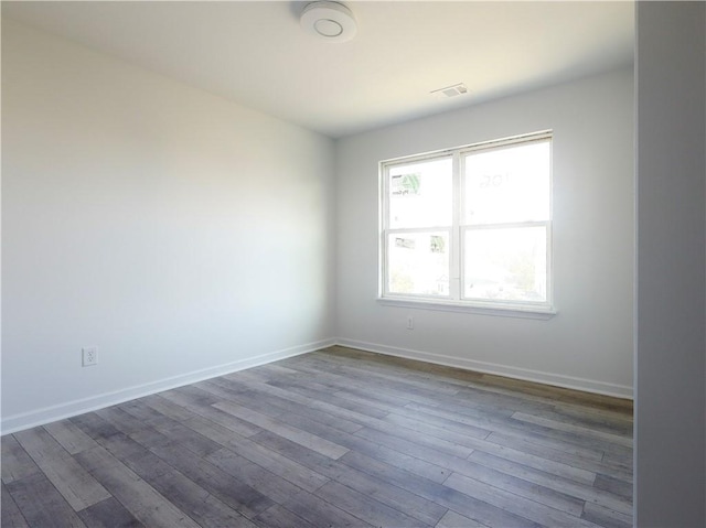 empty room with hardwood / wood-style flooring