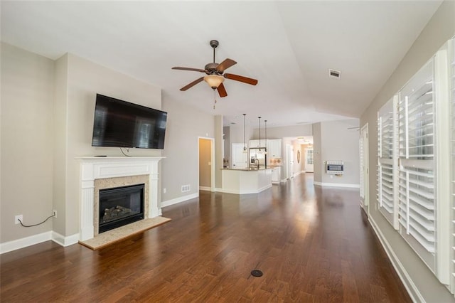 unfurnished living room with dark wood-type flooring and ceiling fan