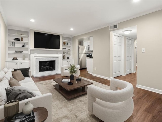95 Ivy Trl NE, Atlanta, GA 30342 - living room featuring wood finished floors, baseboards, a fireplace, recessed lighting, and crown molding