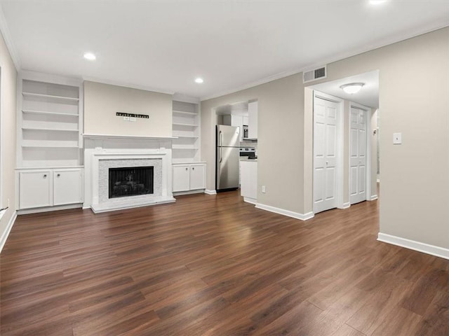 95 Ivy Trl NE, Atlanta, GA 30342 - unfurnished living room with baseboards, dark wood-type flooring, a fireplace with raised hearth, recessed lighting, and crown molding