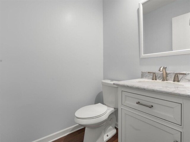 95 Ivy Trl NE, Atlanta, GA 30342 - half bathroom with wood finished floors, vanity, toilet, and baseboards