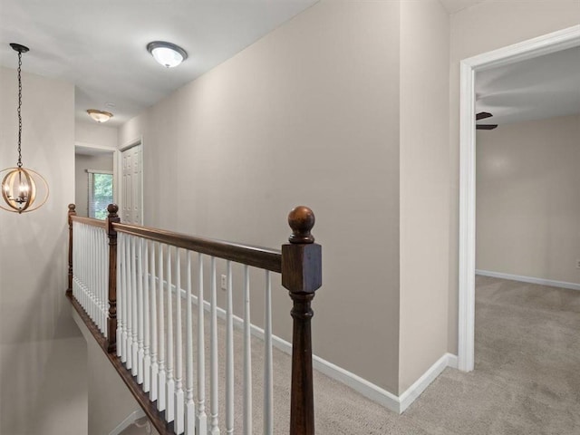 95 Ivy Trl NE, Atlanta, GA 30342 - hallway featuring an upstairs landing, carpet flooring, baseboards, and a chandelier