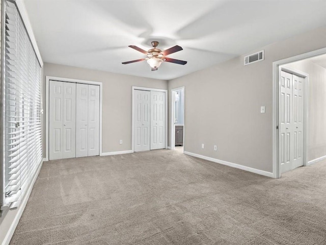 95 Ivy Trl NE, Atlanta, GA 30342 - unfurnished bedroom with two closets, baseboards, carpet, and multiple windows