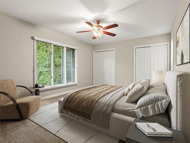 95 Ivy Trl NE, Atlanta, GA 30342 - bedroom featuring two closets, carpet, baseboards, and a ceiling fan