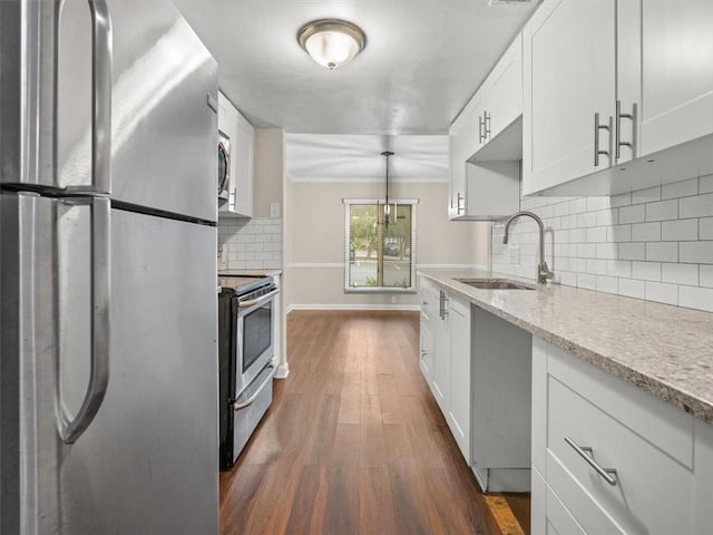 95 Ivy Trl NE, Atlanta, GA 30342 - kitchen with appliances with stainless steel finishes, a sink, white cabinetry, dark wood-style flooring, and tasteful backsplash