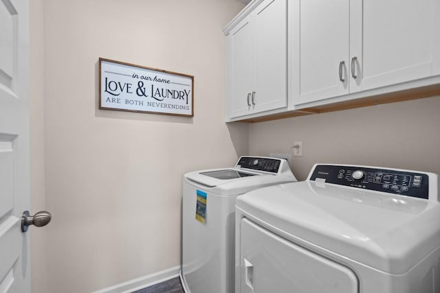 clothes washing area featuring cabinet space, independent washer and dryer, and baseboards