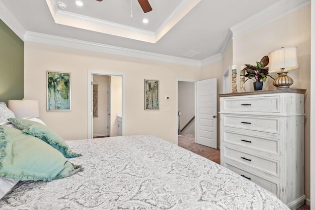 carpeted bedroom featuring recessed lighting, a tray ceiling, ceiling fan, and crown molding