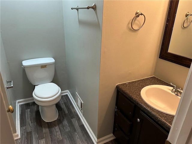 bathroom with vanity, hardwood / wood-style flooring, and toilet