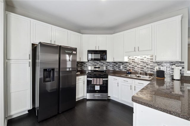 kitchen featuring white cabinets, decorative backsplash, dark wood-type flooring, stainless steel appliances, and a sink