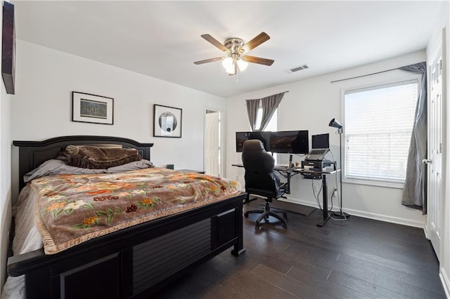 bedroom featuring dark wood-style floors, visible vents, ceiling fan, and baseboards