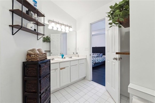 ensuite bathroom featuring tile patterned flooring, vaulted ceiling, vanity, and ensuite bathroom