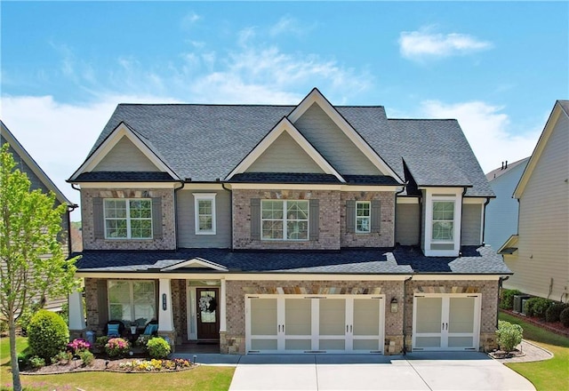 715 Laura Jean Ct, Buford, GA 30518 - craftsman-style home featuring a garage, driveway, roof with shingles, and brick siding