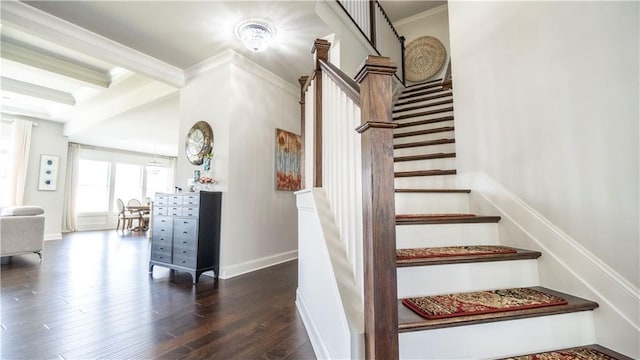 stairs featuring baseboards, ornamental molding, and wood finished floors