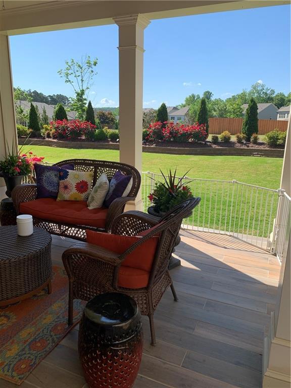 wooden terrace with outdoor lounge area and a yard