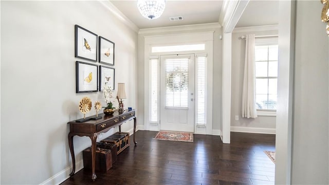 foyer featuring ornamental molding, a wealth of natural light, visible vents, and baseboards