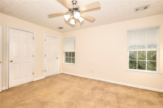 6344 Wellington Walk Way, Lithonia, GA 30058 - unfurnished bedroom with light colored carpet, baseboards, a textured ceiling, and ceiling fan