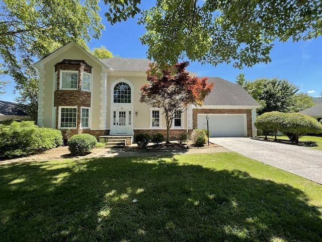 view of front facade with french doors, a front yard, and a garage