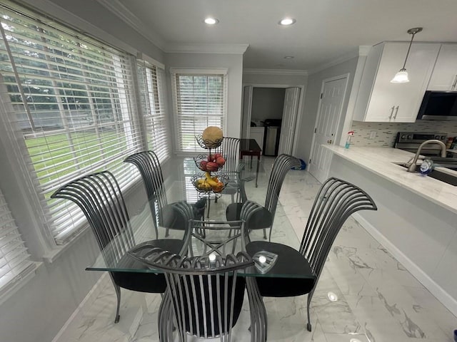 dining room featuring ornamental molding and washing machine and dryer