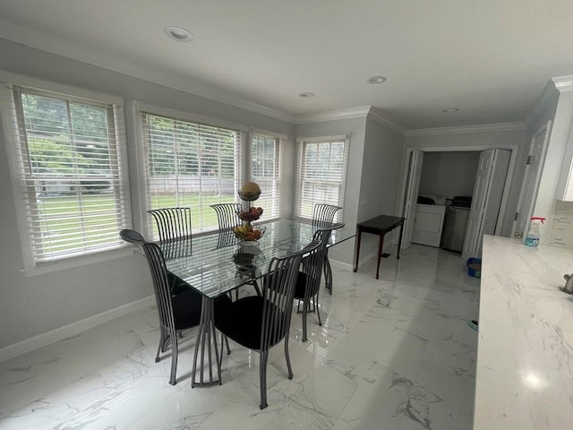 dining space featuring crown molding, a healthy amount of sunlight, and washing machine and clothes dryer