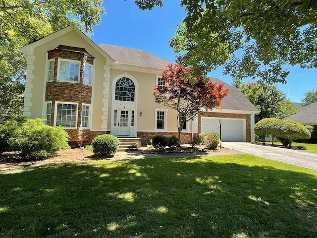 view of front facade with a front yard and a garage