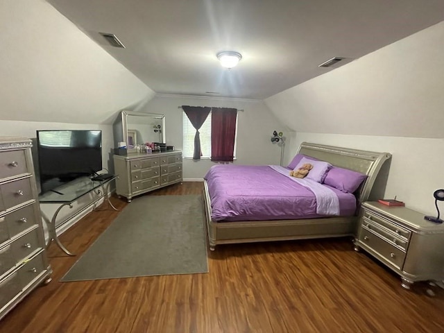 bedroom featuring lofted ceiling and dark hardwood / wood-style floors