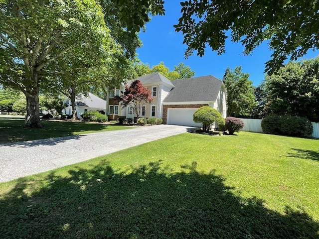 view of front of home with a garage and a front lawn