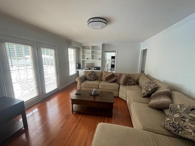 living room with wood-type flooring and ornamental molding