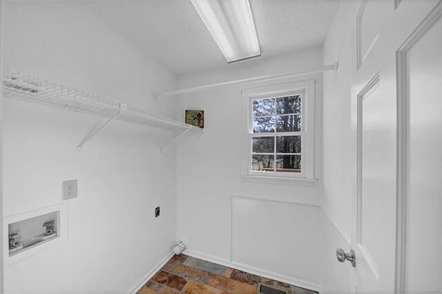 clothes washing area with hookup for an electric dryer and hookup for a washing machine