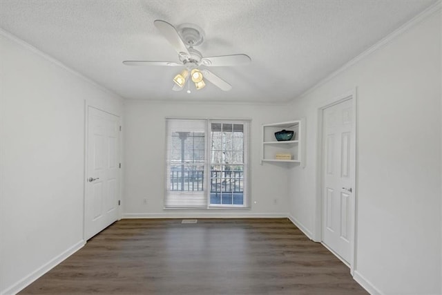 unfurnished room with ceiling fan, crown molding, dark wood-type flooring, and a textured ceiling