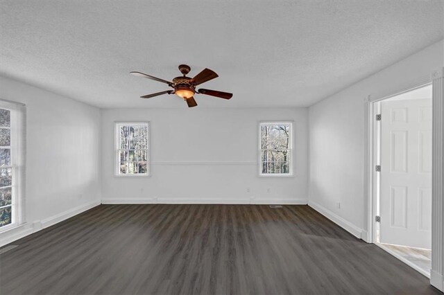 empty room with a textured ceiling, ceiling fan, and dark wood-type flooring