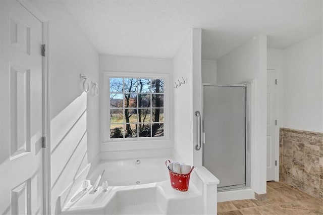 bathroom featuring shower with separate bathtub