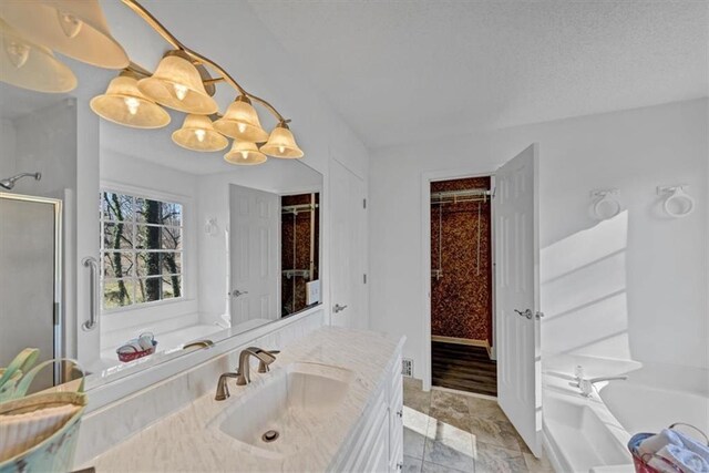 bathroom featuring plus walk in shower and vanity