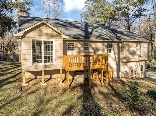 back of house featuring a yard and a wooden deck