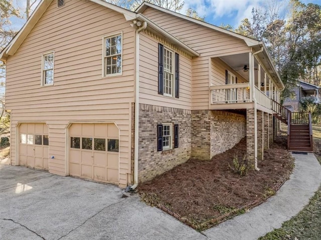 view of home's exterior with a balcony, a garage, and ceiling fan