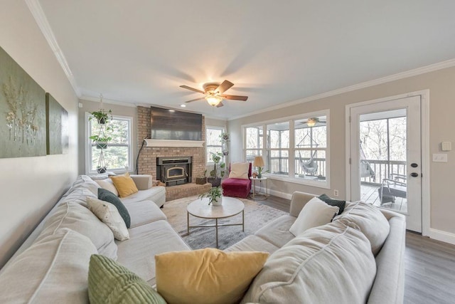 living room featuring ceiling fan, hardwood / wood-style floors, and crown molding