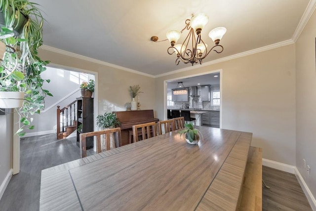 dining room with crown molding, a wealth of natural light, and a notable chandelier