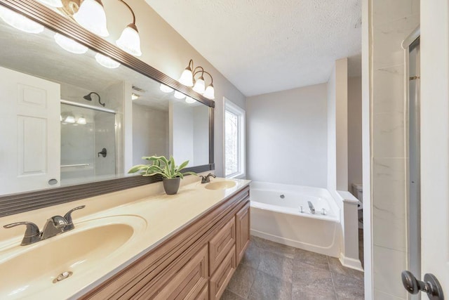 bathroom with vanity, plus walk in shower, and a textured ceiling