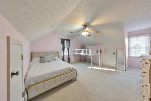 carpeted bedroom featuring ceiling fan, a textured ceiling, and vaulted ceiling