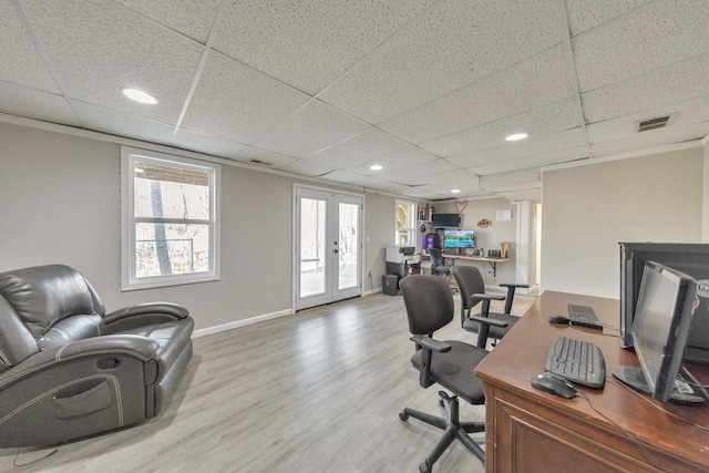 office area with a paneled ceiling, hardwood / wood-style floors, and french doors