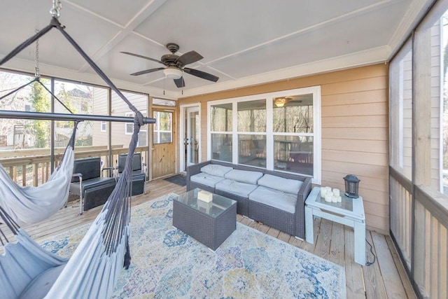 sunroom / solarium featuring ceiling fan, a healthy amount of sunlight, and coffered ceiling