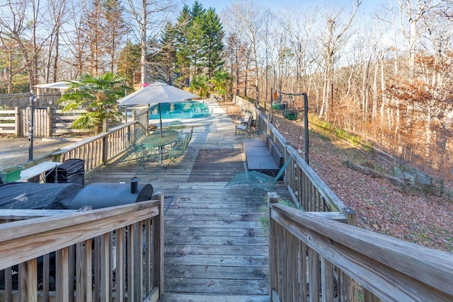 wooden terrace with a pool