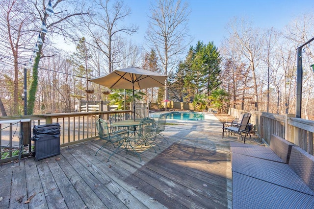 wooden terrace featuring a fenced in pool