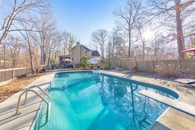 view of pool featuring a diving board