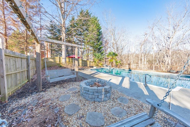 view of swimming pool featuring a fire pit