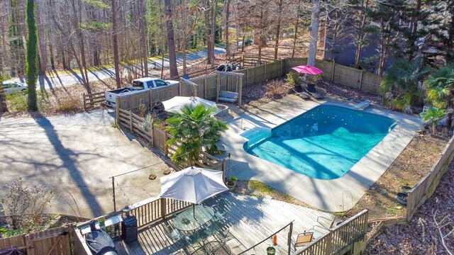 view of swimming pool with a diving board and a deck